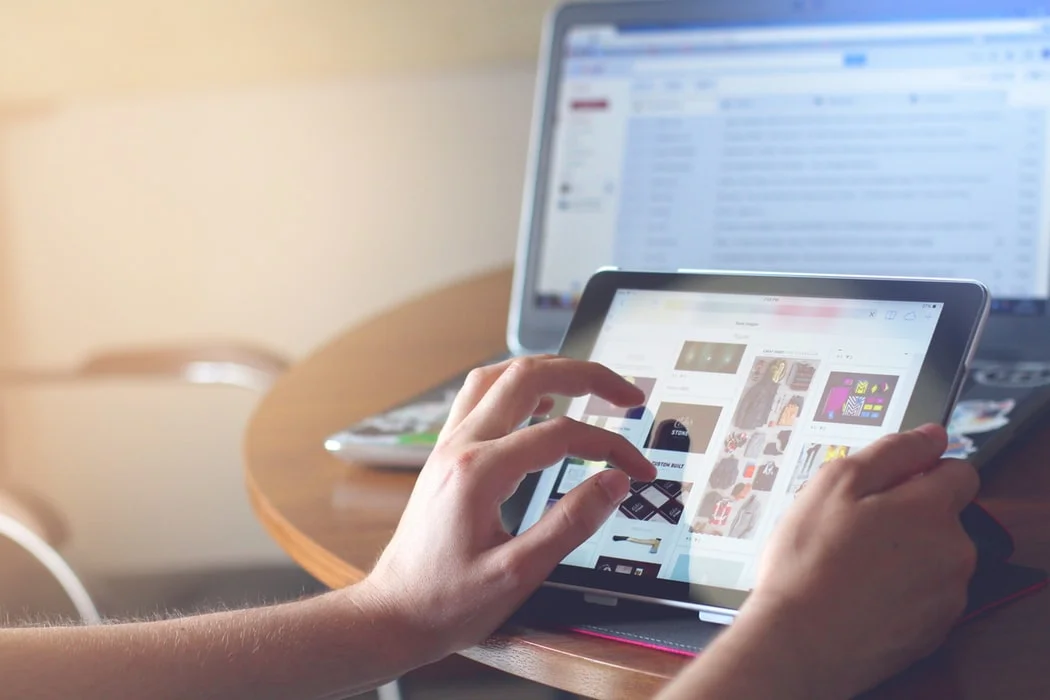 person holding a tablet browsing the web